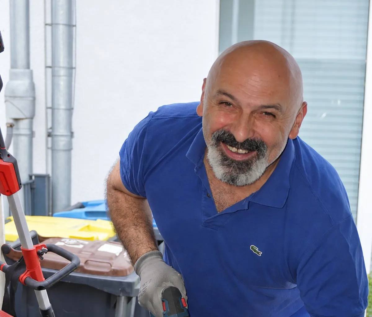 Zafer Sen mit Akkuschrauber und Werkzeugkoffer bei einer Kleinreparatur